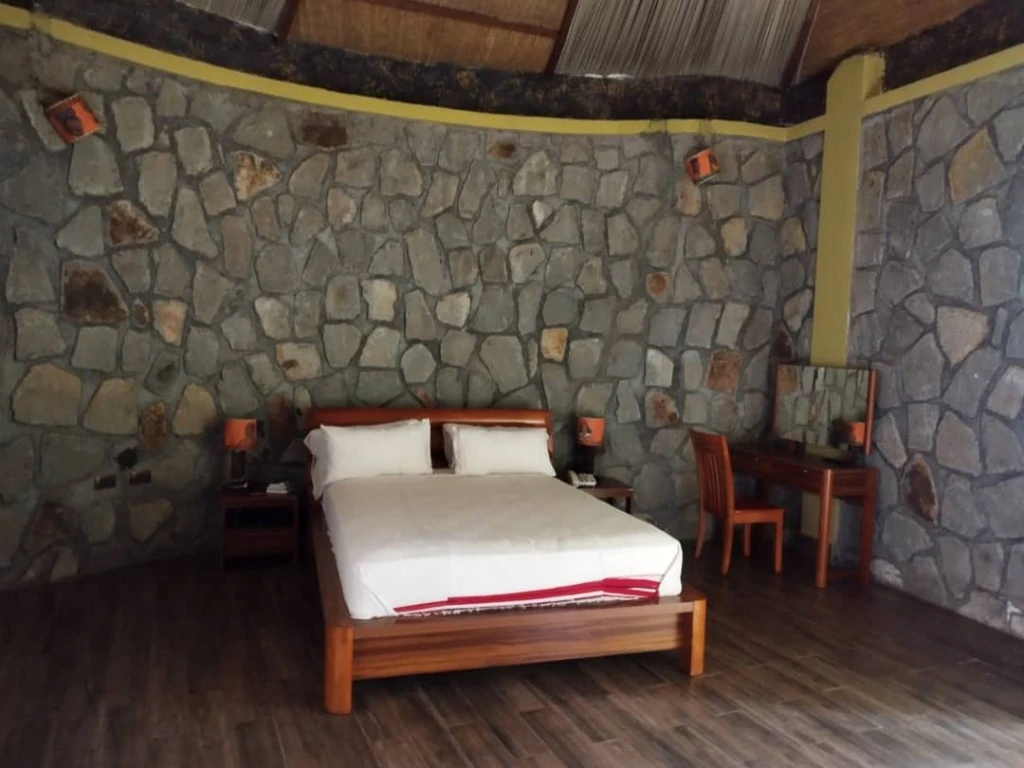 Luxury Suite with timber bed, dressing table and natural stone masonry